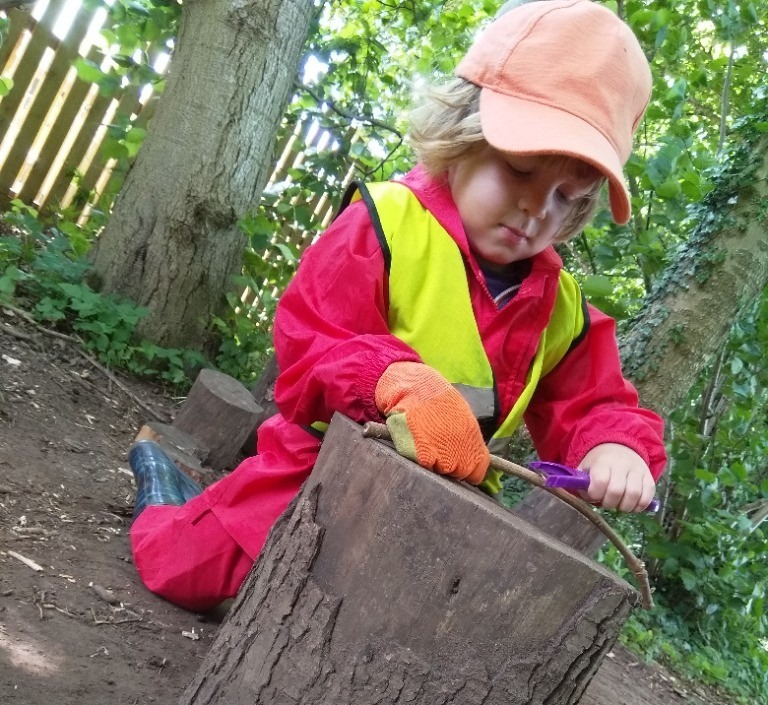 Child exploring at Forest School